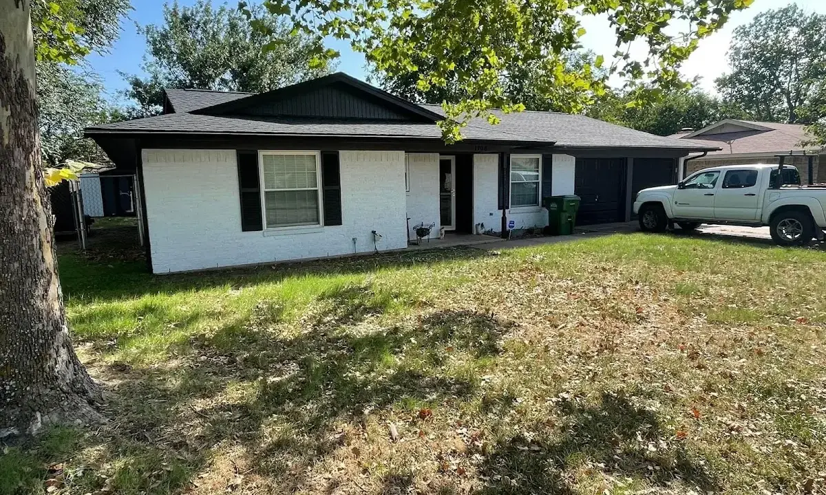 Professional roofing crew working on a residential roof in Highland Park